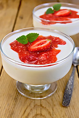 Image showing Dessert milk with strawberry in goblet on board