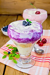 Image showing Dessert milk with cherry and blueberries on napkin