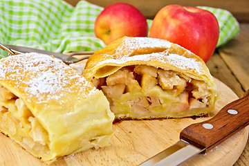 Image showing Strudel with apples and napkin on board