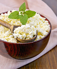 Image showing Curd in wooden bowl with spoon on board