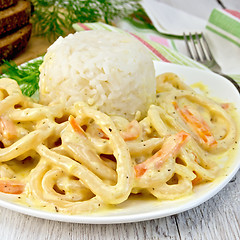 Image showing Calamari in cream sauce with rice on board