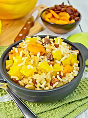 Image showing Pilaf fruit with pumpkin in pan on board