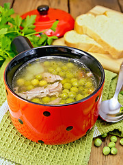 Image showing Soup from green peas with meat in red bowl