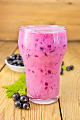 Image showing Milkshake with black currants on board