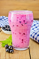 Image showing Milkshake with black currants and napkin on board