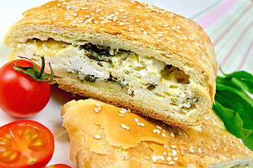 Image showing Roll filled with spinach and cheese on linen tablecloth