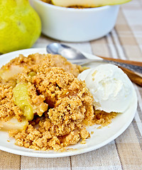 Image showing Crumble with pears in bowl on linen tablecloth