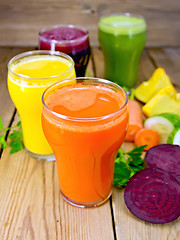 Image showing Juice vegetable in four glasses on wooden board
