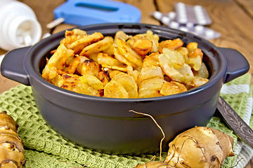 Image showing Jerusalem artichokes roasted in pan with meter on board