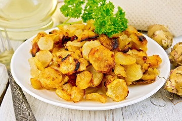 Image showing Jerusalem artichokes fried in plate on light board