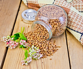 Image showing Buckwheat in glass jar on board with flower