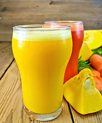 Image showing Juice pumpkin and carrot with vegetables on board