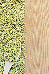 Image showing Lentils green on board on the left with spoon
