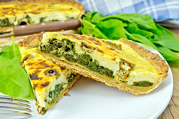 Image showing Pie with spinach and cheese in plate on board