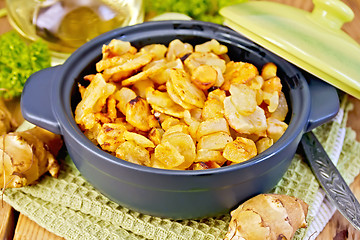 Image showing Jerusalem artichokes roasted in pan on board