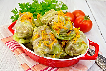 Image showing Cabbage stuffed and carrots in pan on napkin