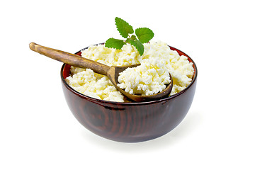 Image showing Curd in wooden bowl with spoon and mint