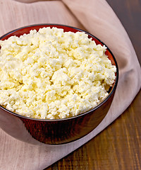 Image showing Curd in wooden bowl with napkin on board