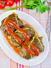 Image showing Rhubarb leaves stuffed in bowl with sauce