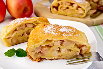 Image showing Strudel with apples in bowl on linen tablecloth