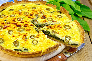 Image showing Pie with spinach and olives on board