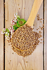 Image showing Buckwheat in spoon with flower on board