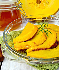 Image showing Pumpkin baked in glass pan with honey on board