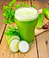 Image showing Juice cucumber with knife on board