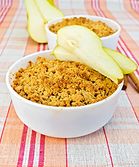 Image showing Crumble with pears in bowl on linen tablecloth