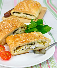 Image showing Roll filled with spinach and cheese on tablecloth