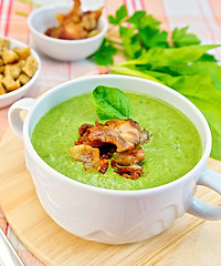 Image showing Soup puree with bacon and croutons on tablecloth