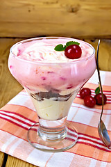 Image showing Dessert milk with cherry on napkin and board