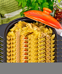 Image showing Cabbage stew with meat in black pot on board