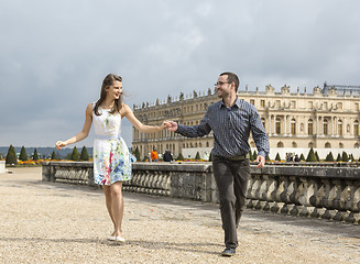 Image showing Happy Young Couple Running Holding Hands