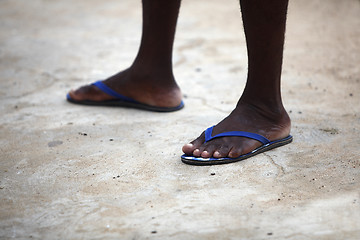 Image showing Feet of an African man in blue flip flops