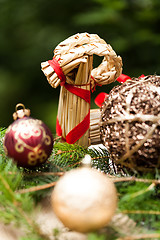 Image showing Gold Christmas ornament on leaves