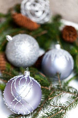 Image showing Silver Christmas ornaments in leaves