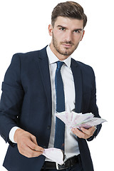 Image showing Wealthy successful businessman burning money