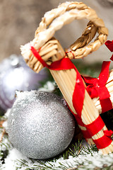 Image showing Silver Christmas bauble on a tree with snow