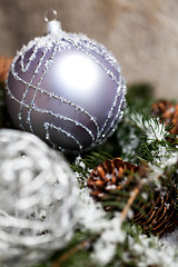 Image showing Silver Christmas bauble on a tree with snow