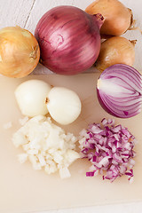 Image showing Whole, peeled and diced brown onion