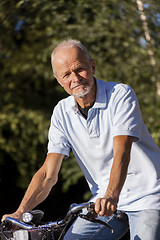 Image showing Senior Man Riding Bicycle