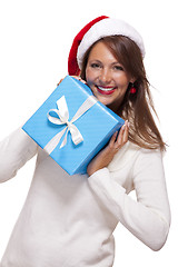 Image showing Beautiful vivacious woman with a Christmas gift