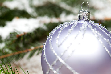 Image showing Silver Christmas ornaments in leaves