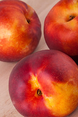 Image showing Three tasty fresh ripe juicy nectarines