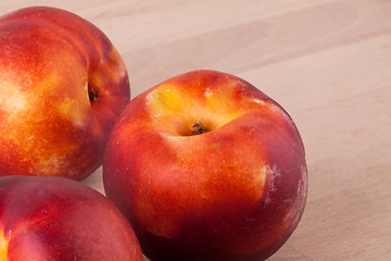 Image showing Three tasty fresh ripe juicy nectarines