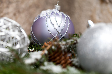 Image showing Silver Christmas bauble on a tree with snow
