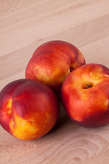 Image showing Three tasty fresh ripe juicy nectarines