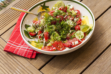 Image showing Bowl of Marinated Greek Salad with Red Napkin