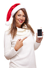 Image showing Pretty woman in a Santa hat reading an sms